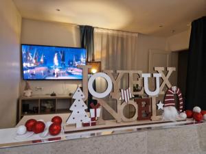 a living room with a tv and christmas decorations at By nuit-parisienne Villemomble joli appartement tout confort in Villemomble