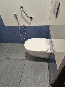 a bathroom with a toilet and a shower at MATHER RAJAGIRI FURNISHED APARTMENTS in Alwaye