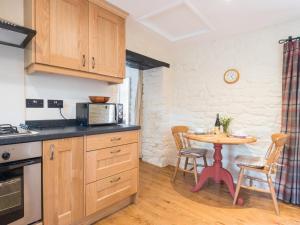 a kitchen with a table and a small table with chairs at 1 Bed in Eden Valley SZ237 in Kirkoswald