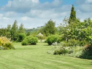 a garden with a gazebo in the background at 1 Bed in Eden Valley SZ237 in Kirkoswald