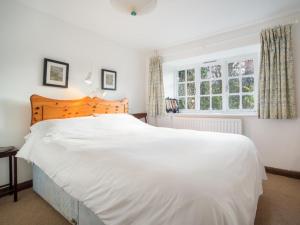 a bedroom with a large white bed and a window at 2 Bed in Patterdale SZ210 in Patterdale