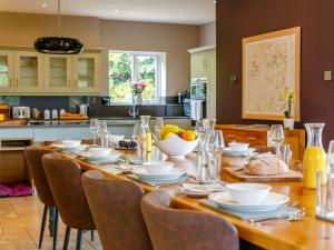 a kitchen with a table with plates and bowls of food at 5 bed property in Durham 85257 in Lanchester