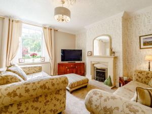 a living room with a couch and a fireplace at 5 bed property in Durham 85257 in Lanchester