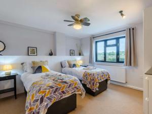 a bedroom with two beds and a window at 2 Bed in Northwich 85877 in Kingsley