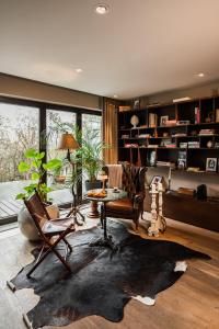 a living room filled with furniture and a large window at Le Petit Chalet in Braşov