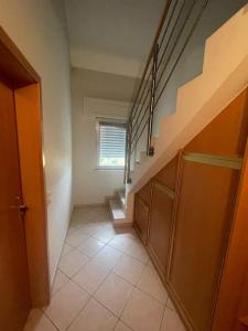 an empty hallway with stairs in a house at Wonderful Duplex in Luxembourg in Pétange
