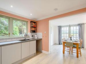 a kitchen with a table and a dining room at 3 Bed in Kippford 88274 in Kippford