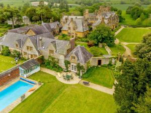 an aerial view of a mansion with a swimming pool at 1 Bed in Minterne Magna 87379 in Cerne Abbas