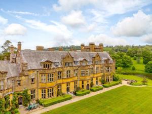 an image of a large mansion with a large yard at 1 Bed in Minterne Magna 87379 in Cerne Abbas