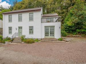 a white house with a green door at 3 Bed in Kippford 88274 in Kippford