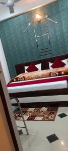a bedroom with two beds with red pillows at Shree Gorakhnath Guest House in Ayodhya
