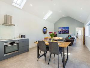 a kitchen and dining room with a table and chairs at 2 bed in Caernarfon 88043 in Caernarfon