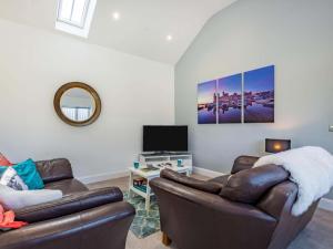a living room with a couch and a tv at 2 bed in Caernarfon 88043 in Caernarfon