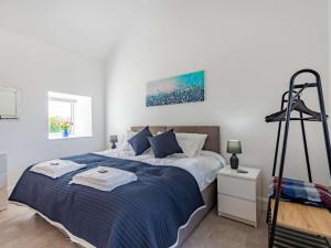 a bedroom with a bed with a blue blanket at 2 bed in Caernarfon 88043 in Caernarfon