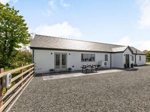 Ce cottage blanc dispose d'une table de pique-nique devant. dans l'établissement 2 bed in Caernarfon 88043, à Caernarfon