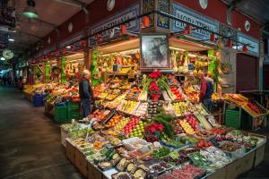 a market with a lot of fruits and vegetables on display at Pierre & Vacances Sevilla in Seville