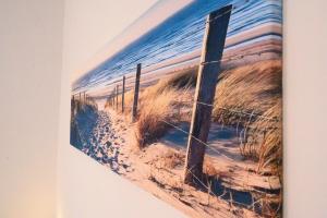 a picture of a fence on a beach at Appartamento Cialdini Centro Ancona in Ancona