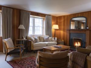 a living room with a couch and a fireplace at Coulin Farmhouse in Kinlochewe