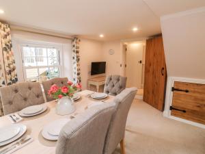 a dining room with a table and chairs at Pilchard Cottage in Dawlish