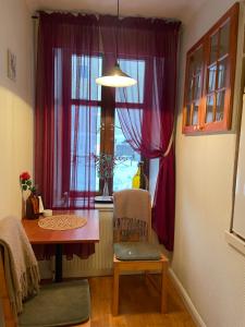 a dining room with a table and a window at Lilla Hotellet in Sundsvall