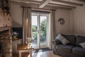 a living room with a couch and a large window at The Granary in Hartland