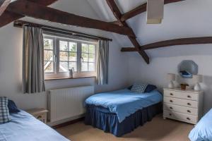 a bedroom with two beds and a window at The Granary in Hartland