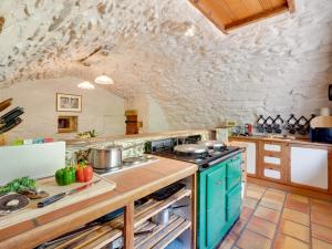 a kitchen with a stove and a stone wall at 5 Bed in Selkirk TOWER in Selkirk