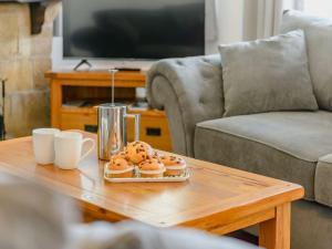 two donuts on a coffee table in a living room at 3 Bed in Pooley Bridge 89068 in Tirril
