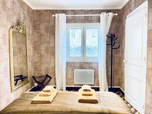 ein Schlafzimmer mit einem Bett und einem Fenster und einem Fernseher in der Unterkunft Maison Petit Arago avec roof terrace et parking privé in Carcassonne + 40 Fotos