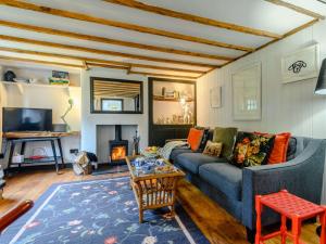a living room with a blue couch and a fireplace at 1 Bed in Bridport 89687 in Bridport