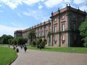 a large brick building with people walking in front of it at B&B La Veduta in Naples