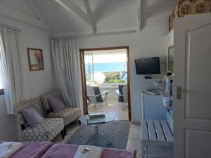 a living room with a bed and a view of the ocean at Paters Haven Self-catering and B&B in Paternoster