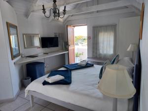 a bedroom with a bed with a table and a window at Paters Haven Self-catering and B&B in Paternoster