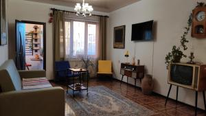 a living room with a couch and a tv at Apartment 11 in Gyumri