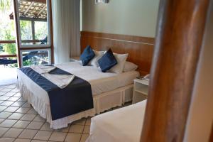 a hotel room with two beds and a window at Pontal da Ferradura in Búzios +65 photos