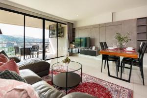 a living room with a couch and a table at The Unity and The Bliss Patong Residence in Patong Beach