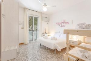 a bedroom with two beds and a balcony at Hotel Cuba in Milano Marittima