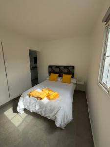 a bedroom with a bed with yellow towels on it at SUNNY CARMELITO DELUXE in Mogán