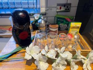 a table with glasses and a blender on it at Dreghorn House 5 b-rooms 9 beds 3 toilets 2 showers,1 bath 2 receiption Secure free Parking 233 Wifi in Edinburgh