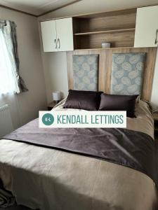 a bed with a sign that reads kendall settings at Oakley (West Sands) in Selsey