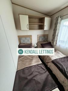 a small room with two beds in it at Oakley (West Sands) in Selsey