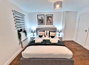 a bedroom with a large white bed with pillows at Manchester Apartments by BEVOLVE - City Centre in Manchester