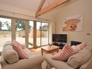 a living room with two couches and a television at 2 Bed in Sherborne 41897 in Yetminster