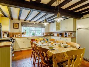 a kitchen with a table and chairs in a kitchen at 6 Bed in Norwich 42594 