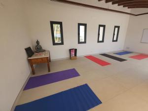 a room with colorful mats on the floor at Agroturisme Es Racó De Maria in Maria de la Salut
