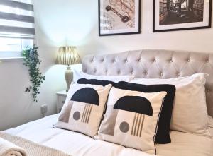 a bedroom with a bed with pillows on it at Manchester Apartments by BEVOLVE - City Centre in Manchester