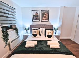 a bedroom with a large bed with two night stands at Manchester Apartments by BEVOLVE - City Centre in Manchester