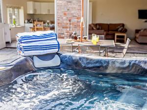 a bath tub with a towel sitting on top of it at 3 Bed in Taunton BLABA in Oake