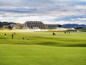 a group of people playing golf on a golf course at 1 Bed in St Andrews 45667 in Ladybank