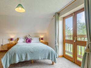 a bedroom with a bed and a large window at 3 bed in Worcester CC037 in Clifton upon Teme